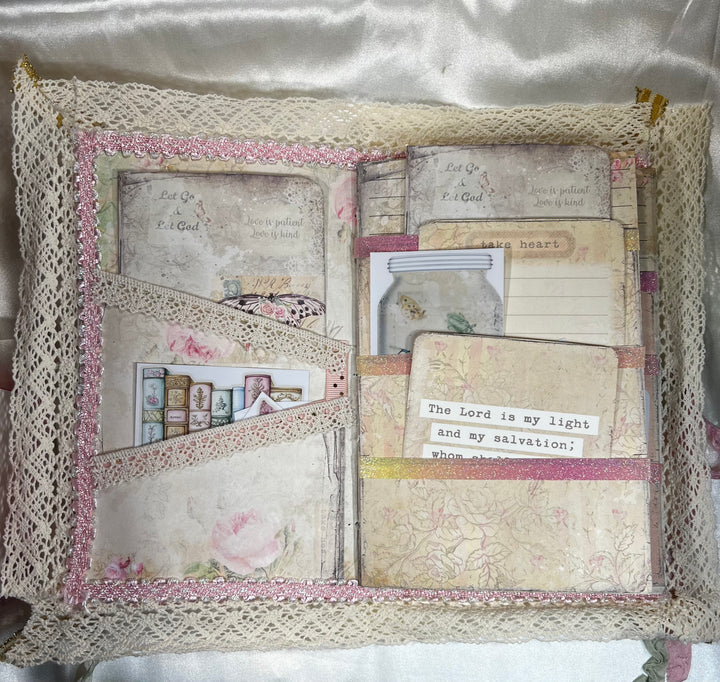 Inside Pockets trimmed with lace and ribbon. Pockets are full of stickers and Journaling cards.