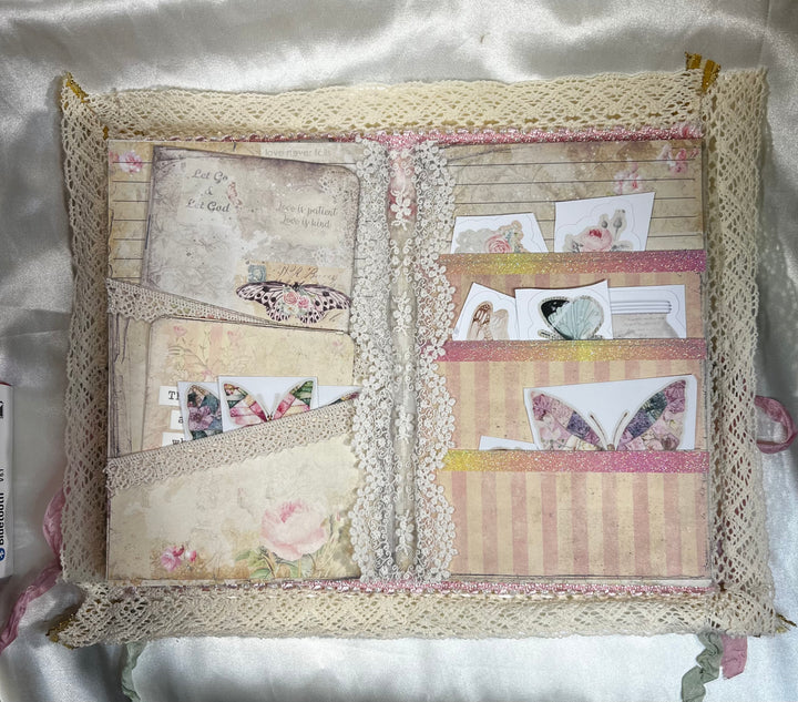 Middle of Journal is full of lace and ribbon lined pockets. Pockets are full of stickers and journaling note cards!