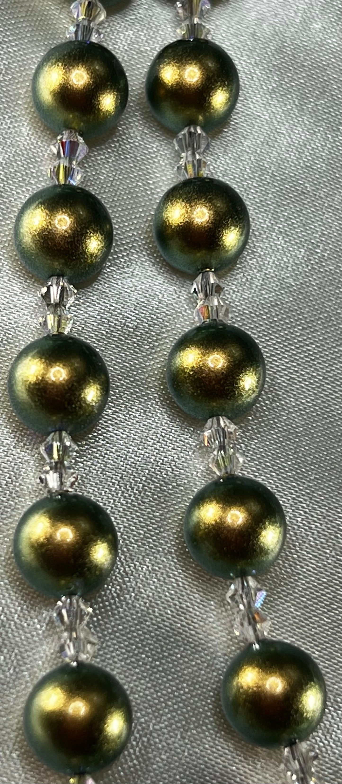 Iridescent Green Swarovski Pearl beads with Swarovski Crystal spacers.