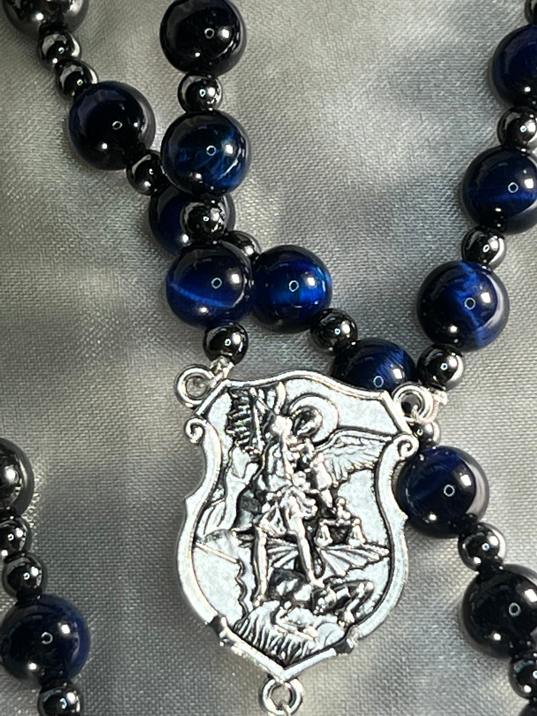 Royal Blue Tiger's Eye beads, Plated Hematite spacers with Silver St. Michael Centerpiece