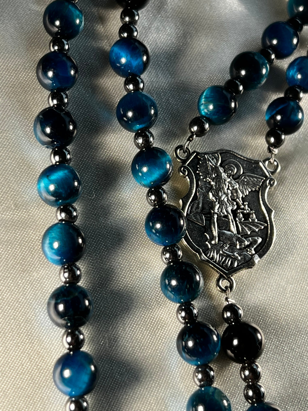 Aquamarine Tiger's Eye beads, Plated Hematite spacers with Silver St. Michael Centerpiece